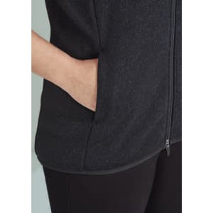 A black vest featuring a zip front and side pockets, with a smooth fabric texture. It has a branding logo.