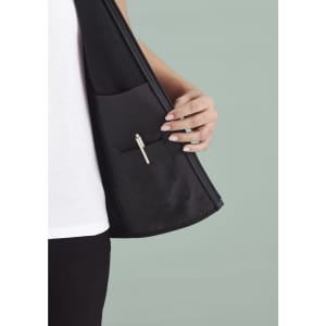 A black women's vest with a zip front and an inner pocket, showcasing the interior design details.