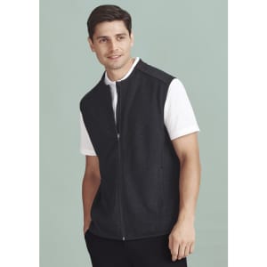 A men's black zip-front vest is worn over a white polo shirt, featuring a sleek, modern design.