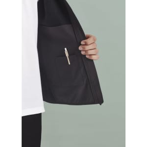 A black vest featuring an inner pocket with a pen holder, showcased against a muted background.