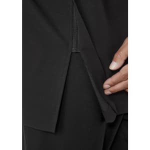 A close-up of a black jacket featuring a zippered opening and a hand demonstrating the detail.