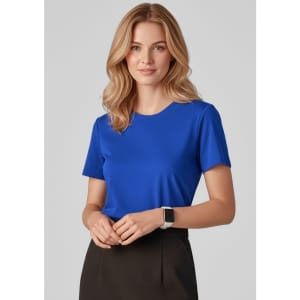A blue women's short sleeve jersey top with a round neckline, worn by a model with wavy hair.