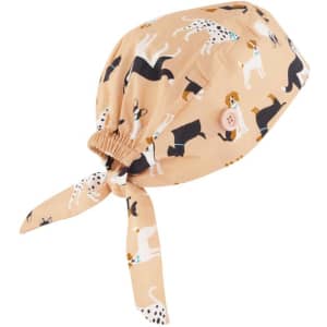 A unisex scrub cap with a beige background, decorated with various dog patterns and a tie at the back.