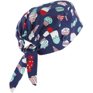 A unisex printed scrub cap in navy featuring colourful patterns of ice cream and desserts, with a tied back design.
