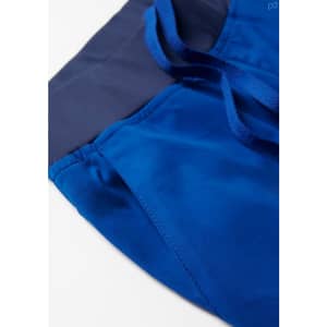 A close-up of women's scrub pants featuring a slim leg design in vibrant blue with a navy waistband and ties.