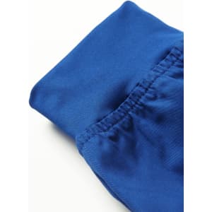A close-up of blue women's jogger scrub pants featuring elasticised cuffs and a smooth fabric finish.