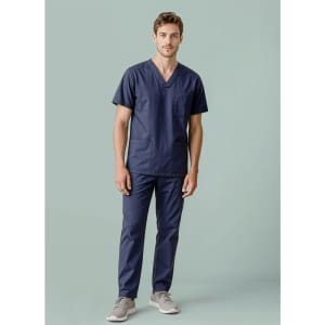 A unisex navy scrub top features a V-neck design and two pockets, worn by a model with matching scrub pants.