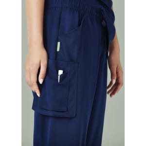 Navy blue women's straight leg scrub pants with a side pocket, featuring a logo.