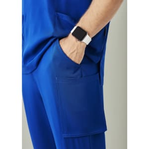 Blue straight leg scrub pant featuring pockets, worn with a watch on the wrist.