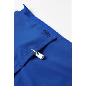 A vibrant blue women's scrub top featuring a pocket with a white toggle. The fabric has a smooth texture.