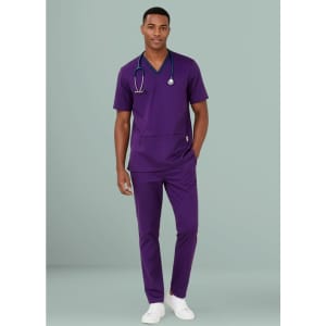 A man wearing a purple scrub top and matching pants, with a stethoscope around his neck.