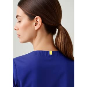 A unisex reversible scrub top in blue, featuring a simple design and a logo at the back neckline.