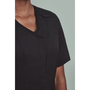 A black women's scrub top with a zip front and crossover design, featuring short sleeves and a logo.