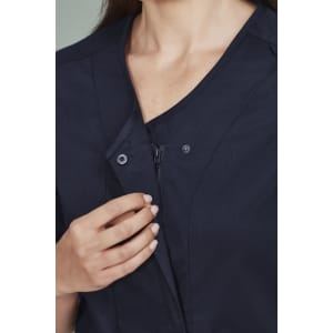 A navy zip-front scrub top featuring a crossover design, with buttons and a smooth fabric finish.