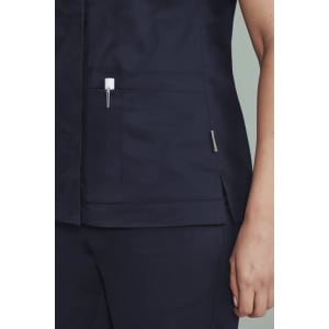 A navy blue women's scrub top featuring zip front closure and pockets, with a stylish design and branding.