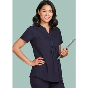 A women's navy tunic scrub top with a relaxed fit, featuring a button-up neckline and a logo on the chest.