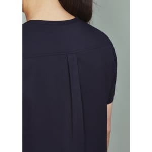 A women's rose tunic scrub top, featuring a sleek design with a pleat detail at the back. The fabric is dark navy.