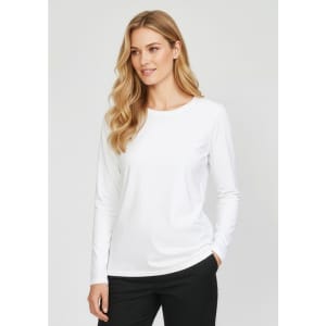 A women's performance long sleeve tee in white, featuring a round neckline and a relaxed fit. It has a logo on the sleeve.