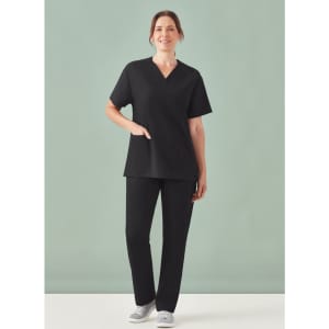A unisex black V-neck scrub top with short sleeves, paired with matching black pants, styled casually.