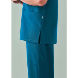 A unisex pulse v-neck scrub top in teal, featuring side slits and a pocket.