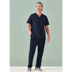 A unisex pulse V-neck scrub top in navy blue worn with matching scrub pants, featuring a logo.