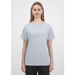 A light blue women's short sleeve tee displayed on a model, featuring a simple design and a logo.