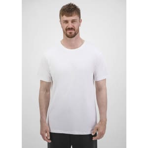 A man stands in a plain white short sleeve tee, featuring a crew neck design and a simple branding logo.