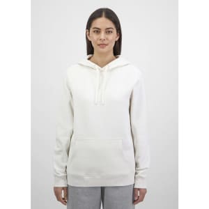 A women's hoodie in a soft white colour with a front pocket and a drawstring hood, featuring a logo.