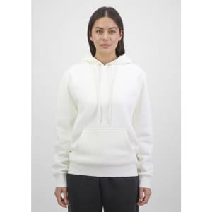A white women's hoodie featuring a front pocket and drawstring hood, displayed on a model against a neutral background.