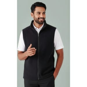 A man wearing a black plain micro fleece vest with a zip and a white shirt underneath. The vest has a collar and a logo.