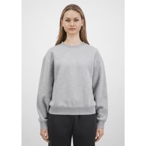 A grey women's crew sweatshirt is displayed, featuring long sleeves and a relaxed fit, with a logo on the front.