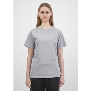 A women's short sleeve tee in grey, featuring a simple design and relaxed fit. The model is standing straight.