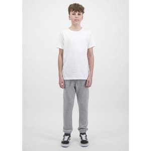 A pair of grey track pants with ribbed cuffs, displayed on a model wearing a white t-shirt and black shoes.