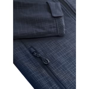 A close-up of a women's navy blue soft shell jacket displaying a textured pattern and zip details. Features a pocket.