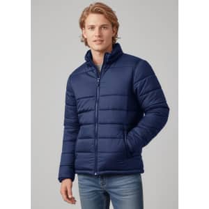 A man wearing a navy puffer jacket stands with a casual pose, featuring a zip-up front and pockets.