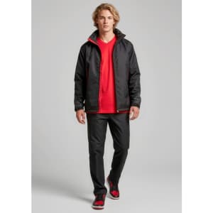 A unisex jacket in black with red accents, featuring a logo, worn over a red shirt and paired with black pants.