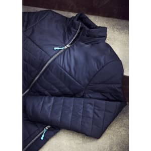 A navy puffer jacket laid out flat, featuring a zip closure and stitched detailing. It has a logo on the zipper.