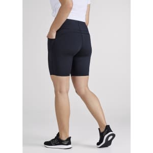 A pair of women's bike shorts in navy blue with a fitted design and pockets, displayed from the back.