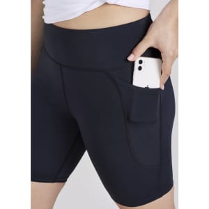 A pair of women's black bike shorts featuring a side pocket for a phone. The shorts have a high waistband for comfort.