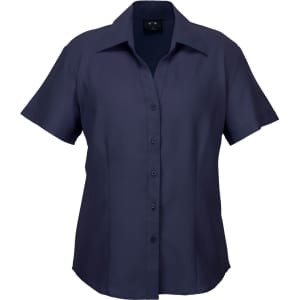 A short-sleeve, button-up women's shirt in navy blue, featuring a sleek design and a logo on the label.