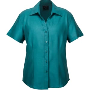 A short-sleeve button-up shirt in teal with a collar and a front button placket. It features a logo.