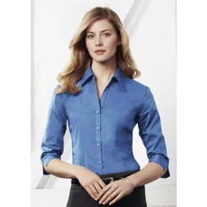 A women's button-up shirt in a vibrant blue with 3/4 sleeves and a collar, featuring a logo.