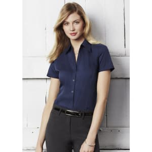 A women's short sleeve button-up shirt in navy blue, featuring a collar and a sleek fit.