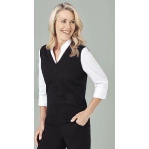 A black women's vest featuring a V-neck design, worn over a white collared shirt. The model is smiling and styled casually.