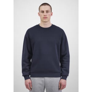 A navy blue men's crew sweatshirt displayed on a model, featuring a simple design and equipped with a logo.