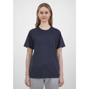 A women's short sleeve tee in navy blue with a relaxed fit, paired with light grey pants. The tee has a logo.