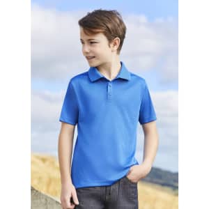 A blue short sleeve polo shirt for kids, featuring a collar and buttons, against a cloudy sky backdrop.