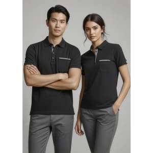A black short sleeve polo shirt for women features a front pocket and is paired with grey trousers. It has a logo.