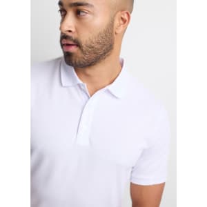 A short sleeve polo shirt in white, featuring a collar and a branding logo on the chest.