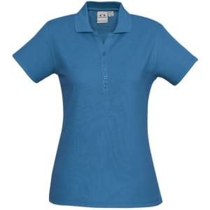 A blue ladies polo shirt featuring a collar and button placket, with a logo on the fabric.